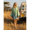 Blonde model wearing an elegant flowing kimono jacket, posed gracefully outdoors in lush green grass.